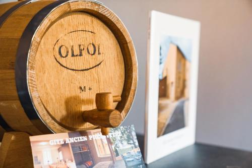 a wooden wine barrel sitting on a table next to a book at Les gîtes Saint-Aignan in Saint-Aignan
