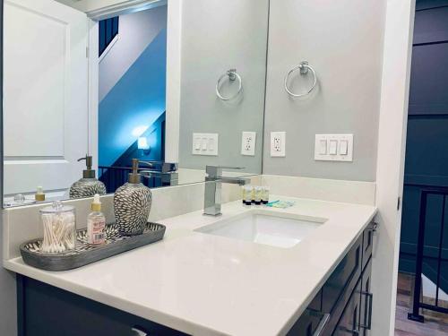 a bathroom with a sink and a large mirror at Upscale 3BDR Penthouse with Rooftop TV and Stunning Capitol and Monument Views Near Popular H Street Corridor Parking Included Free Cancellation in Washington