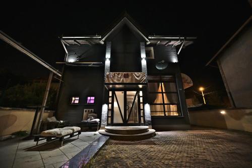 a house at night with a bench in front of it at OFOO Zagreb in Zagreb