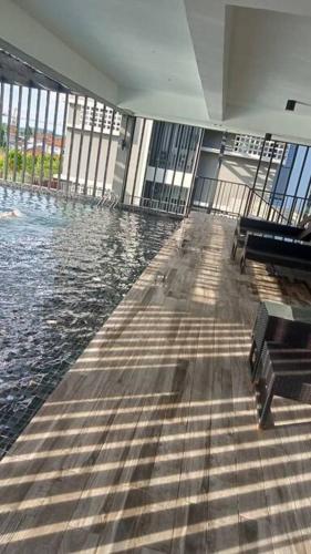 a large swimming pool in a building with water at Yumi Staycation 3R2B, Doncaster Residence in Maong Bazaar
