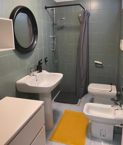 a bathroom with a sink and a toilet and a mirror at Casa in campagna vicino Polignano A Mare - EKATOS in Triggianello