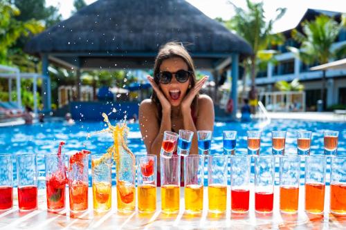 a woman in a pool with a bunch of glasses at Ocean's Creek Beach Hotel in Balaclava