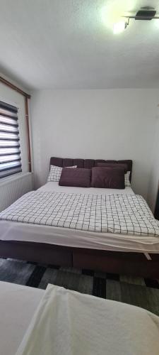 a large bed in a room with at Apartman Dženix in Sarajevo