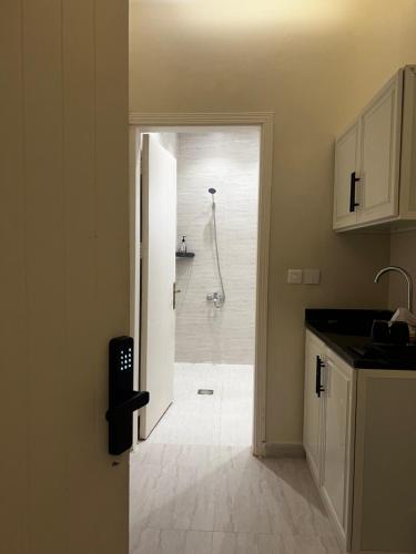a kitchen with a shower in a bathroom at Deluxe Boho - Self Check-in in Riyadh