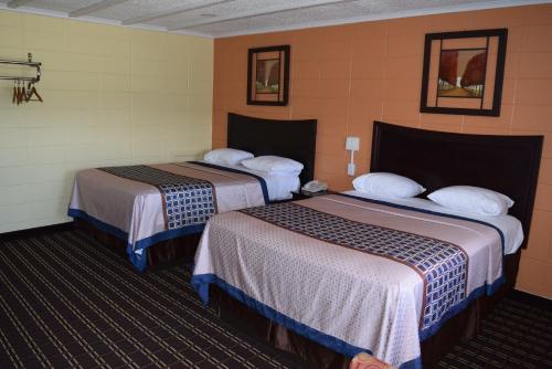 a hotel room with two beds in a room at White Oaks Motel Pennsville/Carneys Point in Pennsville