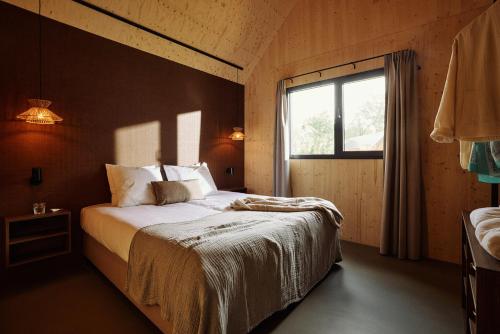 RoldeResort Roodewoud的一间带大床的卧室，带窗户