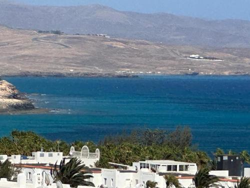 a view of a large body of water with white buildings at Casa Adriana in Costa Calma