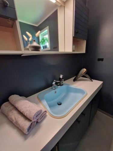 a bathroom with a sink and a towel on a counter at Fjellhagen - Geirangerfjord view in Hellesylt