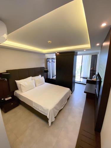 Una cama o camas en una habitación de Visse Hotel