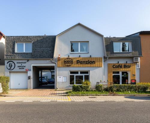 a store front of a building with a car dealership at Penzion Rodos - Café in Prague