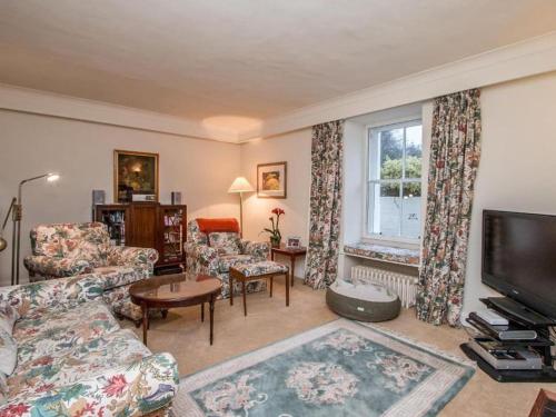 a living room with a couch and a tv at Country Home on Private Estate in Minishant