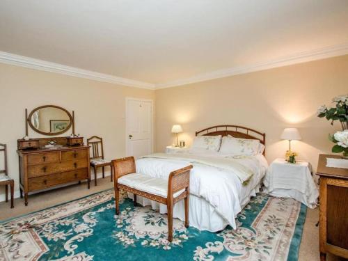 a bedroom with a bed and a dresser and a mirror at Country Home on Private Estate in Minishant