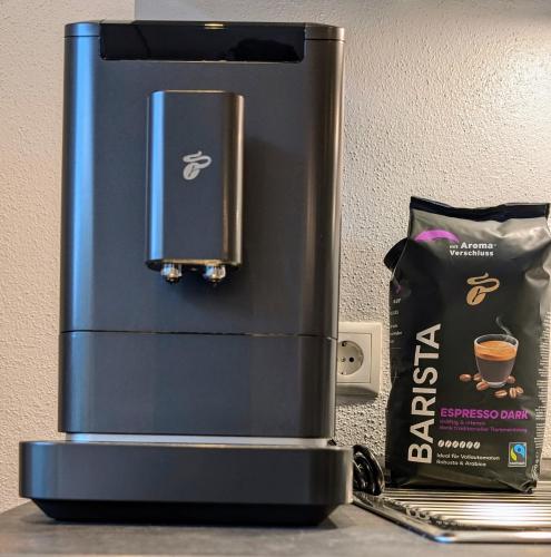 a coffee maker and a bag of coffee on a counter at Penzhaus - Premium Private Suites in Zell am Ziller
