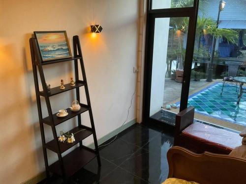 a room with a book shelf next to a door at Cozy breezing countryside Pet in Ban Khlong Sip Sam Lang