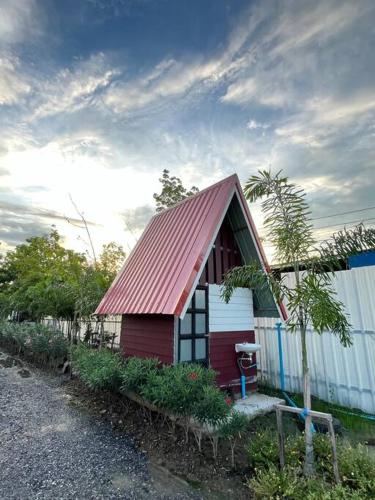 a small red and white house with a red roof at Cozy breezing countryside Pet in Ban Khlong Sip Sam Lang