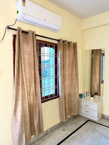 a room with curtains and a window at Aero homes in Madhapur