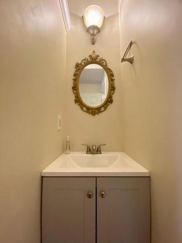 a bathroom with a sink and a mirror at Historic Townhouse Oasis with En-suite Bathroom in Philadelphia