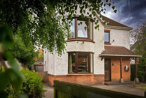 a brick house with a large window on it at Gorgeous Family 3 Bedroom Home in Newbury