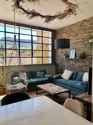 un salon avec un canapé et une table dans l'établissement La Verrière Berges du Tarn - Centre historique, à Millau