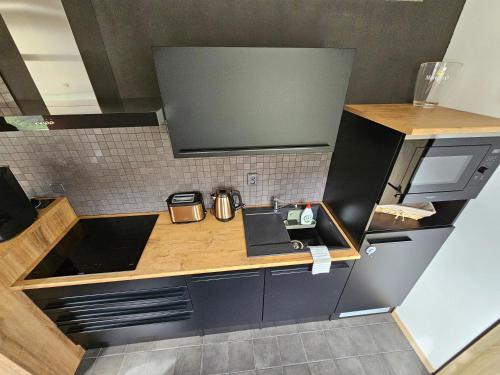 a small kitchen with a sink and a counter at Apartmán Bílá Voda in Červená Voda