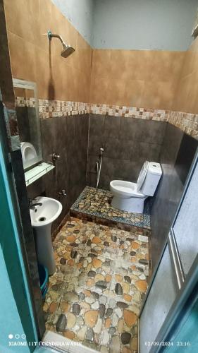 a bathroom with a toilet and a sink at Perhentian Sealife Inn in Kampung Kuala Besut