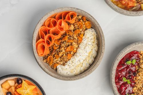 a bowl of food on a table with different foods at HAB Hotel Bogotá in Bogotá
