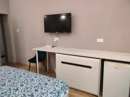 a bedroom with a desk with a tv on the wall at Studio in the centre of Nicosia 2 in Nicosia