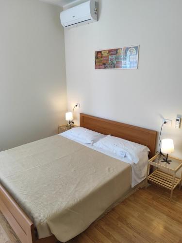 a bedroom with a bed and two lamps on two tables at Il Vecchio Calzaturificio in Civitanova Marche