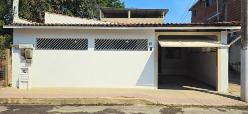 a white garage with a white garage door at Casa BNH in Cachoeiro de Itapemirim