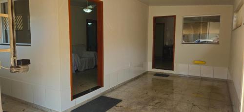 a room with a mirror in the corner of a room at Casa BNH in Cachoeiro de Itapemirim