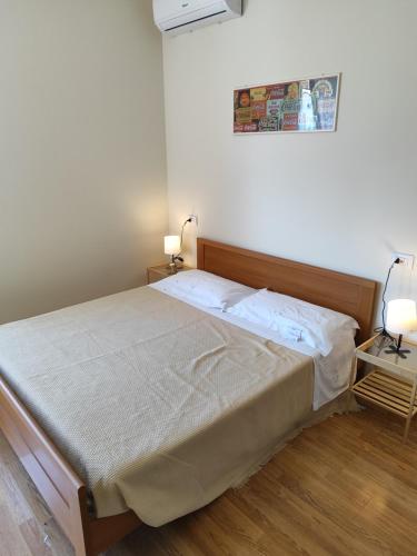 a bed in a bedroom with two lamps on a table at Il Vecchio Calzaturificio in Civitanova Marche