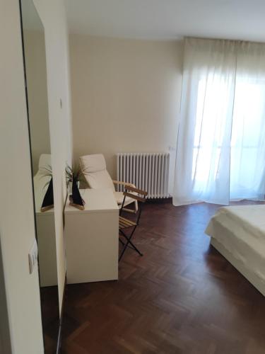 a bedroom with a bed and a desk and a window at Il Vecchio Calzaturificio in Civitanova Marche