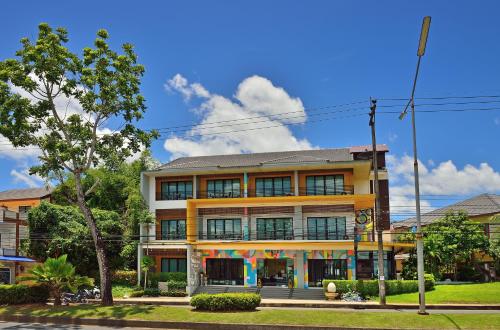 a yellow building on the corner of a street at Tairada Boutique Hotel in Krabi