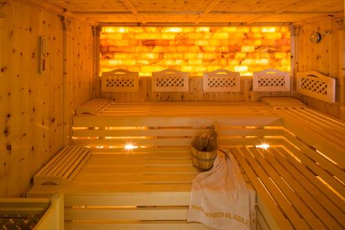 a sauna with benches and a bucket in it at Sonnenhotel Adler Spa & Nature Adults only in Villandro