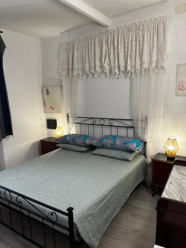 a bedroom with a bed with two pillows at Intellihost - Casa Giulietta Lonato del Garda in Lonato