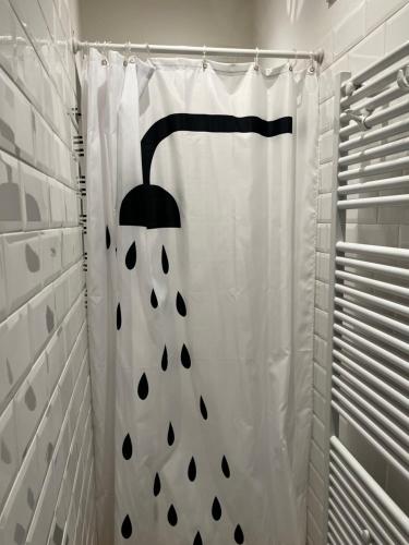 a shower with a black and white shower curtain at Casa Giulietta - Lonato del Garda in Lonato del Garda