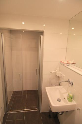 a bathroom with a shower and a sink at City Apartments in Erfurt