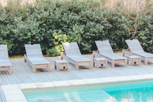 a group of chairs sitting next to a pool at Carilo Vista in Carilo