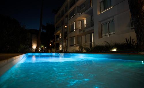 a swimming pool in front of a building at night at Carilo Vista in Carilo