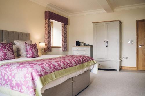 a bedroom with a large bed and a window at The Manor Boutique Hotel Restaurant and Bar in Conwy
