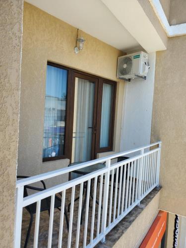 a balcony of a building with a window and a heater at Hotel N in Tskaltubo