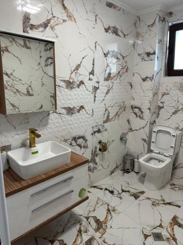 a bathroom with a sink and a toilet at The Hillside Villa in Ognyanovo