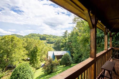a view from the porch of a cabin with a view of the forest at Ridgeview in Blowing Rock