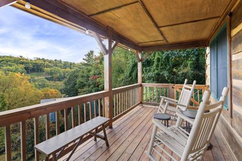 a porch with two chairs and a bench on it at Ridgeview in Blowing Rock