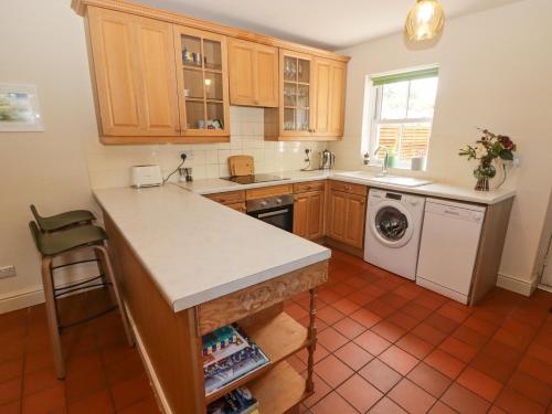 a kitchen with a counter and a dishwasher at Clearbrook Lodge in Carmarthen