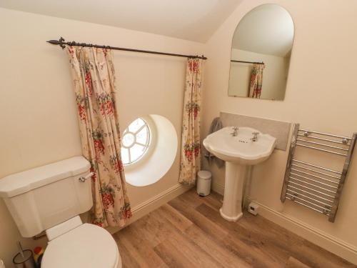 a bathroom with a toilet and a sink at Clearbrook Lodge in Carmarthen
