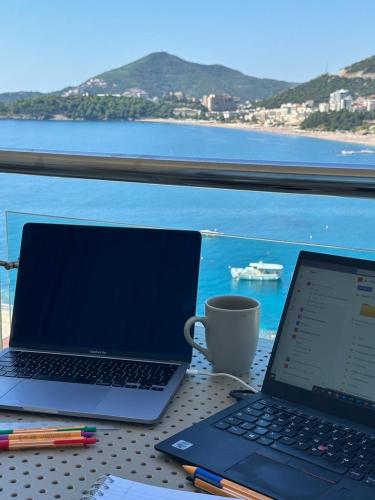 two laptops on a table with a view of the ocean at Workation Panorama Escape in Budva