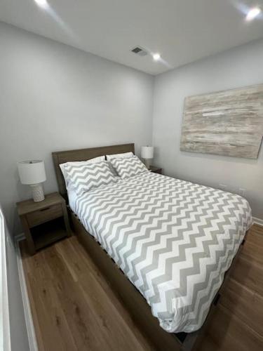 a white bedroom with a bed and a night stand at 2BR Columbia Heights APT Walk 2 Metro & Shops in Washington
