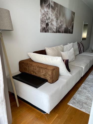 a white couch with pillows on it in a living room at Workation Panorama Escape in Budva