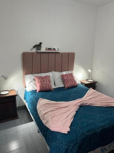 a bedroom with a large bed with two pillows on it at Los Cactus in La Rioja